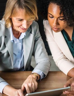 women watching gray tablet computer